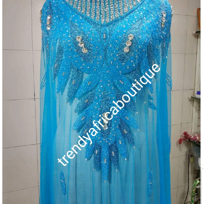 Turquoise blue Heavily-beaded net for making blouses. Popularly use by Igbo/Delta/edo women for big Occasions. Comes in 1.8yds lenght already design for your beautiful blouse